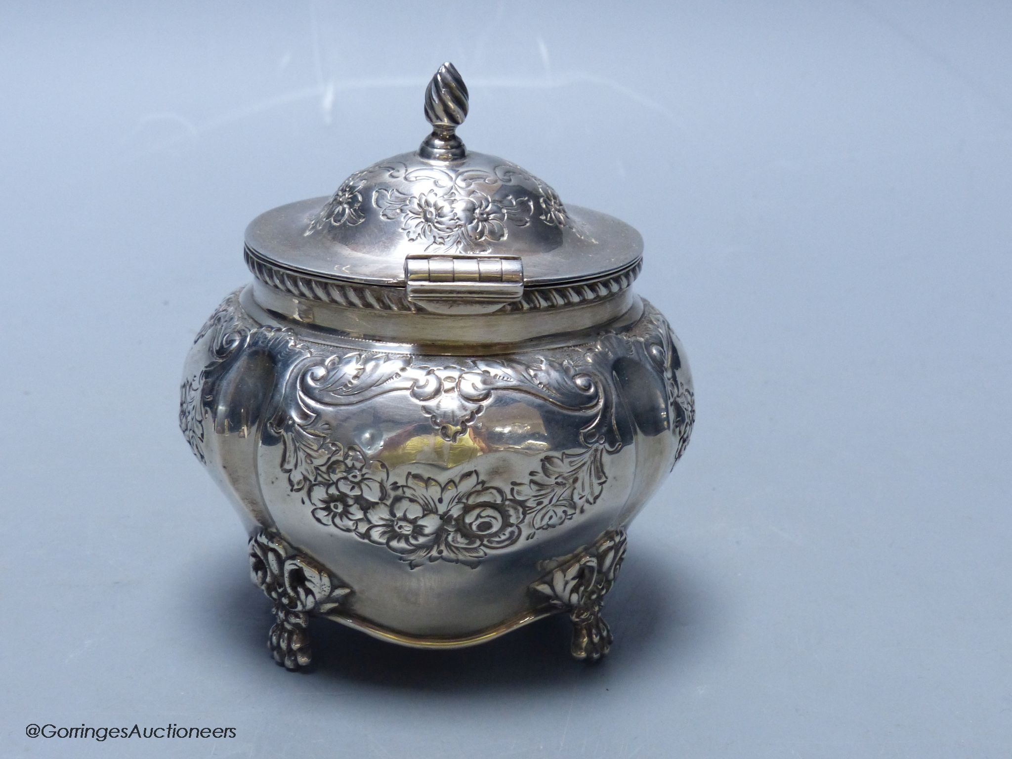 An Edwardian embossed silver bombe shaped tea caddy, Williams (Birmingham) Ltd, Birmingham, 1903, height 11cm, 5.5oz.